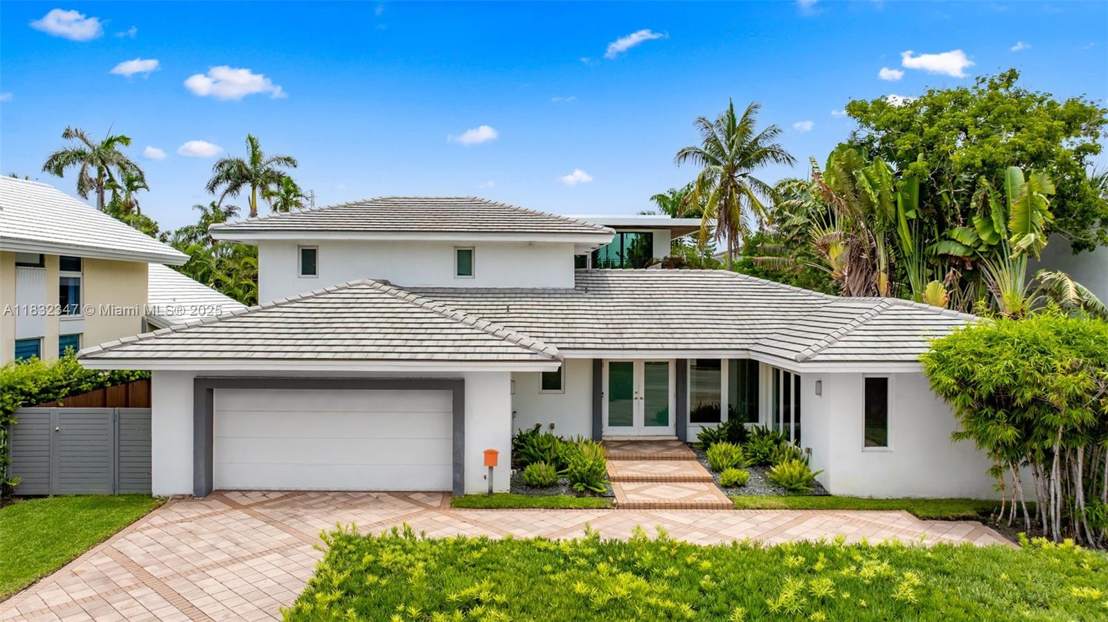A Spacious House with Soul – Where Chic Design Meets Tranquil Living. Step into a sanctuary on prestigious Bay Harbor Islands. This stunning two-story home offers four-beds, three-and-a-half-baths, an Italian-designed open kitchen, and elegant marble and wood floors. Enjoy indoor-outdoor living with French doors opening to a large pool and serene entertaining space. The primary suite features a private office, walk-in closet, and balcony. Complete with a stylish built-in bar, oversized two-car garage, and a short walk to Bal Harbour Shops and the beach, this is elevated, intentional living at its finest.