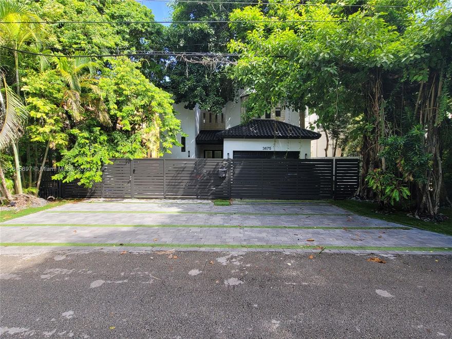 Spectacular and elegant 4,433 Sqft mini mansion in South Grove. Walking distance to Coco-Walk village, restaurants, shopping and prestigious schools such as Ransom, Carrolton, St. Stephen's, Plymouth, St. Hugh.  Stunning beautiful banyan tree canopy adorns the front of the home. Crema Marfil marble floors throughout.  Impressive, conversation piece, Indonesian stove hood, new marblelite counter tops, over-sized Sub-Zero refrigerator & freezer (separate units), Wolf gas stove oven and microwave, practically new Viking dishwasher, U-Line ice maker and wine cooler.  Very private and secured with gorgeous aluminum gate and wood fence all the way around the property. New pavers, and artificial grass recently installed. Coral rock fountain for a serene backyard & plenty of space for a pool.