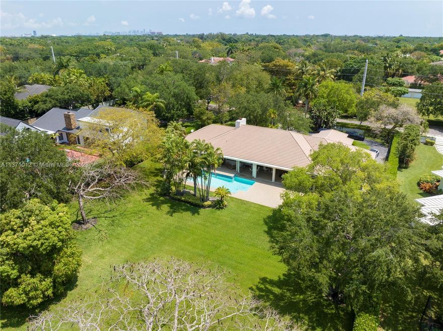 Experience the best one acre lot in North Pinecrest, tucked away and private yet next to Pinecrest Elementary school with East to West exposure! This guarantees most afternoons are bathed in sunlight in your huge back yard whilst enjoying your pool and the large covered patio and barbecue area. This house is gated and fenced and well placed on the lot so that you have enough parking at the front east side of the house whilst enjoying a huge back yard west facing. The layout inside is fabulous with a split plan and a private master with sitting area on one side of the house and on the other 4 large bedrooms with 3.5 baths. Enjoy the vaulted ceilings with a fireplace at the center of the house, a large kitchen and family room and separate dining area.  Large 2-car garage and laundry area!