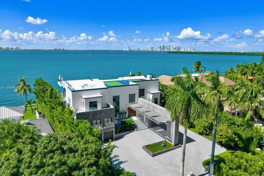 This stunning waterfront home, designed by renowned architect Ramon Alonso of Studio Radyca, exemplifies luxury and resilience. Because of its construction and elevation this home stands as one of the most hurricane-proof residences on the market, located directly on Biscayne Bay with 120 feet of water frontage. Completed in 2014. Enjoy breathtaking views of Miami’s Downtown Skyline and captivating sunsets from expansive balconies and virtually every room. The property features a private dock, soaring ceilings, and a rooftop pickleball court, making it perfect for large-scale indoor and outdoor entertaining. This home seamlessly blends architectural innovation with unparalleled natural beauty, offering a truly exceptional lifestyle.