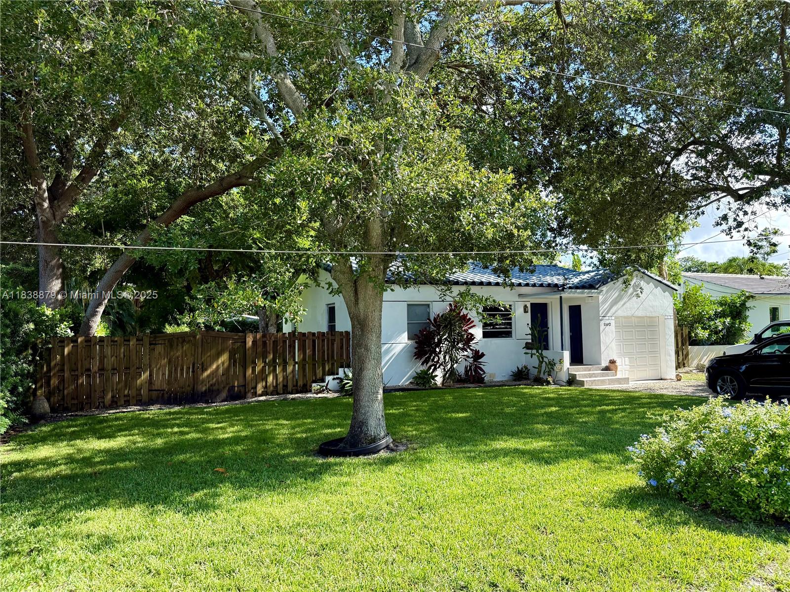 Charming 2BR/1BA home in the heart of Biscayne Park, located on a beautiful and quiet street in one of Miami’s most desirable neighborhoods. Set on an oversized 11,400 sq ft lot, the property offers total privacy and lush tropical landscaping with two mature mango trees. Bright Florida Room overlooks the garden, perfect for relaxing or working from home. Spacious layout, Updated Bathroom, Laundry room, Covered Garage, BBQ area, and plenty of space to entertain or unwind outdoors. Walking distance to parks, kids playground, basketball and volleyball courts. Minutes from the beach, Bal Harbour Shops, Aventura Mall, Wynwood, Design District, Whole Foods, restaurants, paddle courts and more. A true oasis. Great for couples, small families.