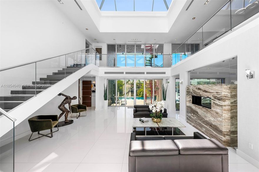 Discover luxury in this custom modern home on a premier Las Olas Isles street. Boasting 121 ft of waterfront with dockage for a 90-ft yacht, this nearly 8,000 sq ft residence features 7 bedrooms and an open floor plan. Enjoy a top-tier kitchen, gas fireplaces, elevator, integrated lighting/sound systems, skylights, and impact windows. The private oasis includes a stunning rooftop deck with artificial grass, perfect for entertaining. With an active Airbnb license, this property offers exceptional short-term rental potential for lucrative income. Located minutes from Las Olas Blvd, it blends sophistication and technology for an unmatched lifestyle.