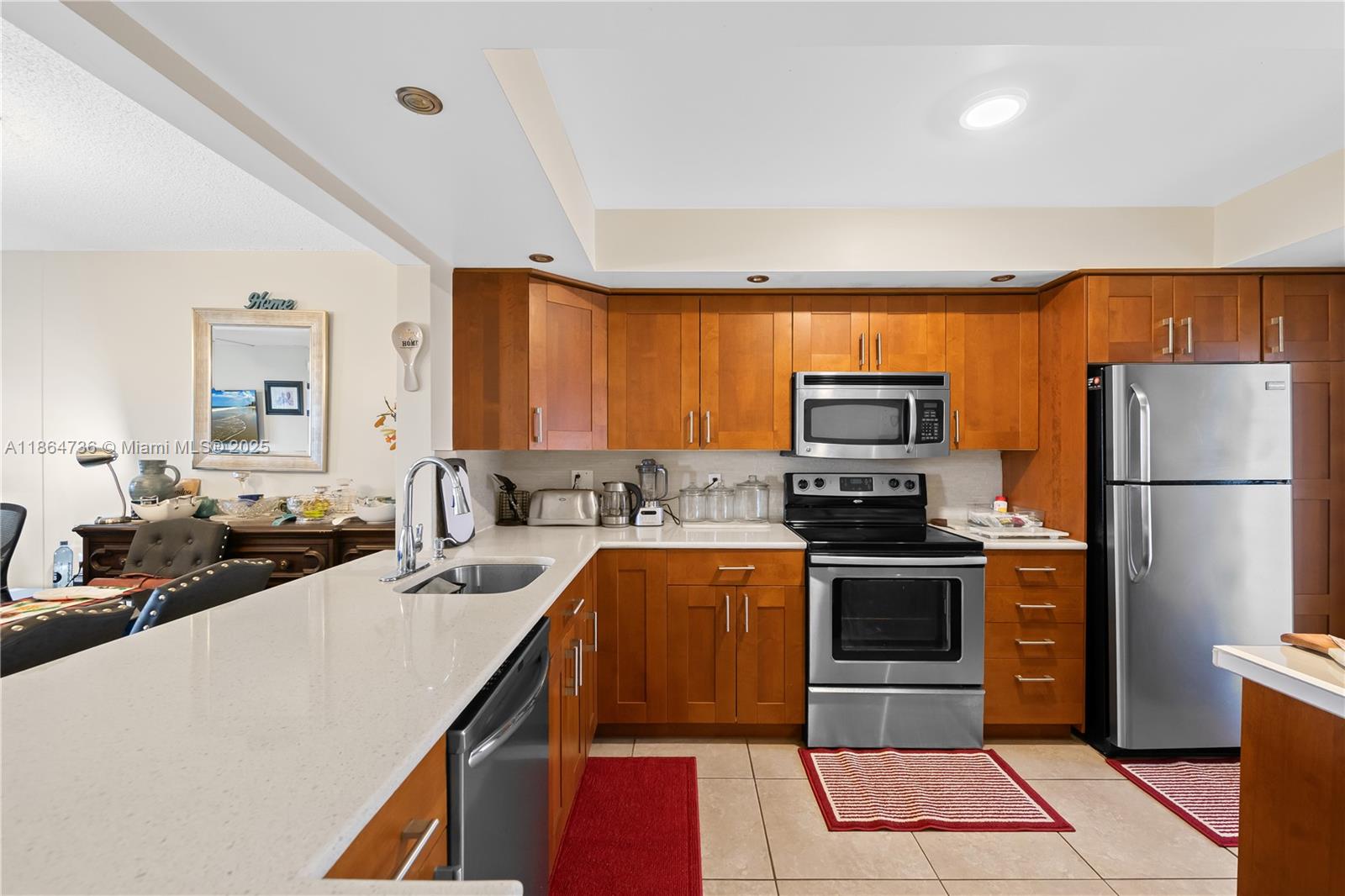 Welcome to this inviting 55+ community, located just 20 minutes from the beach. This charming 4th-floor condo features an open-concept kitchen ideal for gatherings and upgraded bathrooms with tasteful finishes. Enjoy peaceful lake views from your private balcony while being minutes from the Turnpike, shopping, dining, and a nearby hospital. The community includes 24/7 security. A perfect blend of comfort, convenience, and a prime location.