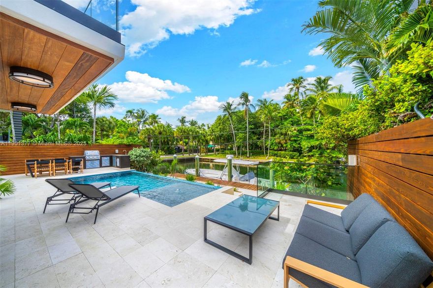 A Modern Boater’s Paradise — This exceptional waterfront residence in Coconut Grove seamlessly blends architectural elegance with contemporary comfort. Completely reimagined, the 4BR/4BA home features Italian porcelain flooring, white oak finishes, bespoke millwork, and Lutron lighting throughout. The chef’s kitchen is a showpiece with Sub-Zero and Wolf appliances, a built-in coffee system, Grand Viola marble countertops, and custom cabinetry. Thoughtful upgrades include a new roof, new impact windows and doors, and new electrical, ACs and plumbing. Outdoors, lush tropical landscaping, a sparkling new pool, summer kitchen, and integrated sound system frame 50 feet of private dockage offering direct, unobstructed bay access. Excellent location close to Brickell and Center Grove.