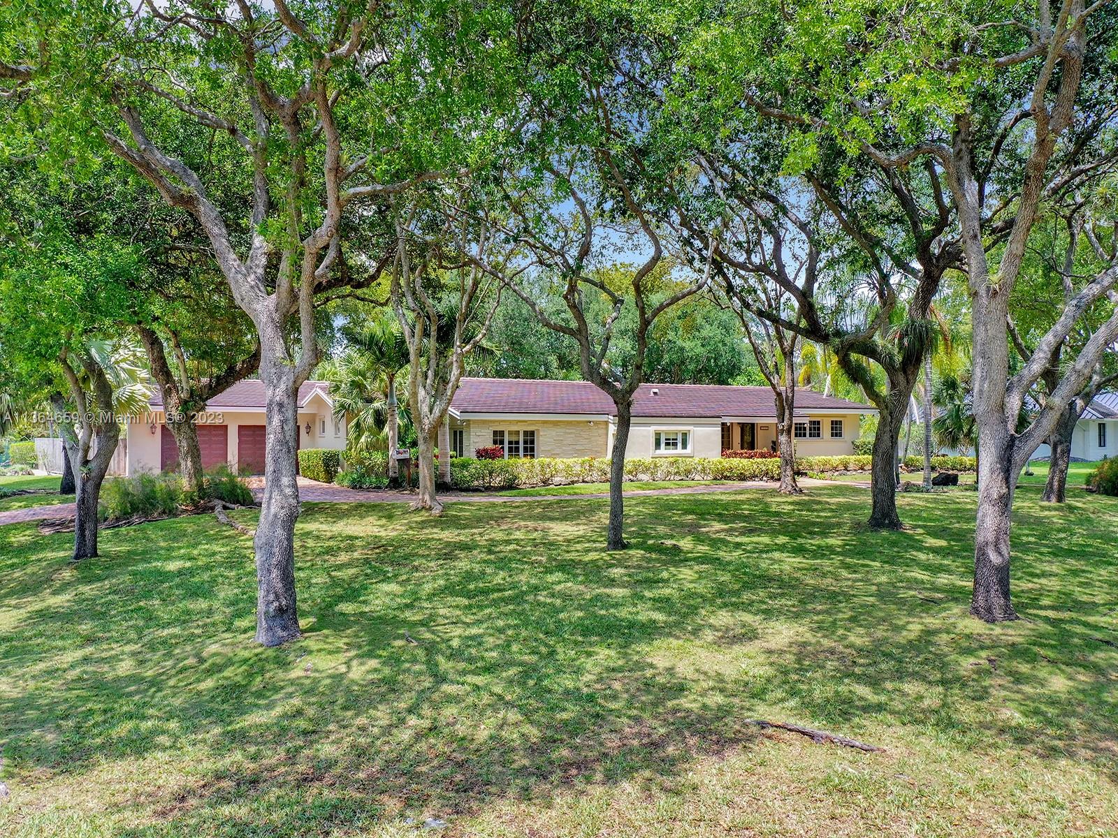 A luxurious entertainer's paradise awaits in this picturesque 5,134sf home situated on over 33,000sf on a quiet no through street in Pinecrest. Drive into the large circular Chicago brick driveway surrounded by majestic oak trees, transporting you into complete serenity. Upon entry into the foyer, you'll be greeted into the formal living and dining room where you'll be captivated by sweeping views of the lush pool and expansive backyard. The large chef's kitchen complete w/Bosch & KitchenAid appliances transitions into a warm and inviting family room. The primary suite offers 2 large walk-in closets, w/a bonus room that is primed for an office, gym, or more. All bedrooms are ensuite. Complete w/a 2019 roof, 2-garage, & whole-house generator, this is an opportunity you won't want to miss.