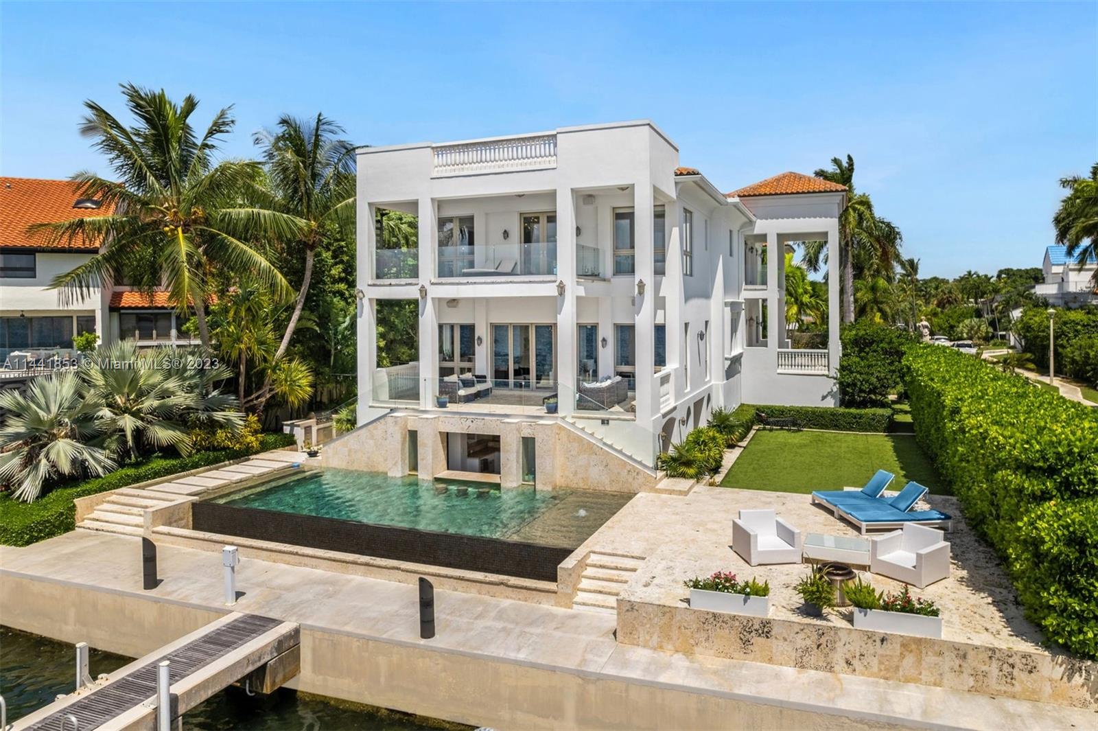 Coconut Grove's Crystal View Mansion boasts 80 ft. of open waterfront on Biscayne Bay, a private dock, & a heated pool with a swim-up bar. Stay fit in the gym, unwind in the spa with steam & sauna, or enjoy a game of pool or poker in the ground-level lounge. A gourmet chef's kitchen is showcased on the main level with a wine-cellar, home theater, waterfront formal living room with a proper bar, and incredible office/library. Floor-to-ceiling windows encompass the living areas. The primary bedroom is a sanctuary with two bathrooms and walk-in closets, including a rooftop terrace with breathtaking views. The property also features a full guesthouse, three-car garage, security camera and Savant system and an elevator. A private gate and beautiful coral-wrapped wall provide ultimate privacy.