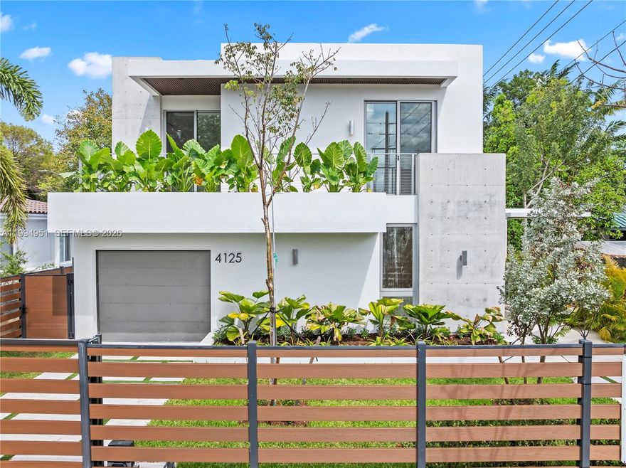 Welcome to OWN Development’s Mega Home, presented by The Azar Team. This exceptional new construction two-story residence offers 4,328 square feet under air and a total of 5,256 square feet of thoughtfully designed living space. Blending modern architecture with functional elegance, the home features 4 bedrooms, a home office, and 4.5 bathrooms, including a full bedroom and bath on the first floor, ideal for guests. A dramatic foyer sets the tone upon entry, leading into an open-concept layout with high ceilings in the main living areas. The seamless flow between the living room, family room, and kitchen creates a bright and inviting atmosphere, enhanced by recessed lighting. Additional flexible spaces include an open den on the first floor and a second den upstairs. The centrally positioned kitchen features Taj Mahal quartzite countertops and backsplash, Thermador appliances, a walk-in pantry, and a clean, modern design. Upstairs, the primary suite offers a private retreat with an en-suite bathroom, while the remaining bedrooms are well-proportioned. Engineered hardwood flooring runs throughout the second floor, adding warmth and a refined finish. The outdoor space is designed for entertaining, featuring a private pool with a heater and salt chlorination system, covered patio, and landscaped yard. The home is fully fenced and includes an automatic gate, CCTV, and surround sound. A balanced layout in prime Miami, close proximity to the Design District.