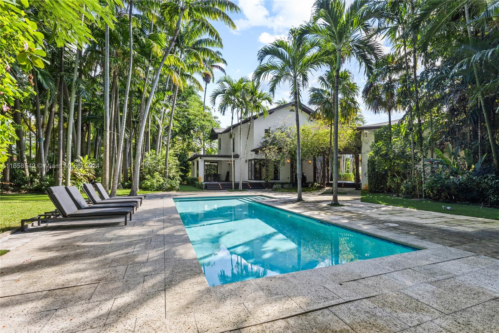 Explore this hidden gem in Spring Garden. This remarkable property is situated on a spacious double lot, surrounded by lush tropical landscaping, providing unprecedented privacy and tranquility. The property includes two homes: a spacious 2-bedroom, 2.5-bathroom main house and a charming 2-bedroom, 1-bathroom guest residence, perfect for extended family or visitors. Relax in the swimming pool or host gatherings for family and friends. Tucked away in a peaceful neighborhood just moments from the city's cultural center, this unique retreat offers the ultimate Miami living experience.