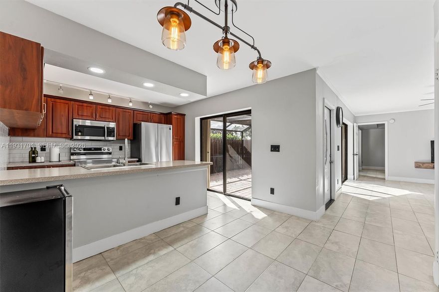 Welcome home to this move-in ready corner-unit townhome in the desirable Village at Lake Pines! With 3 bedrooms, 2.5 baths, and 1,650+ sq ft, this substantially remodeled home delivers space, style, and flexibility. Tile floors throughout, an updated kitchen with modern appliances, and a bright open layout make everyday living easy. Enjoy multiple outdoor spaces including a private courtyard, open balcony, and screened porch—perfect for morning coffee or weekend entertaining. First-floor entry with ground-level bedroom is a major plus. Resort-style amenities include pool, tennis, clubhouse, basketball courts, playground and picnic areas. HOA covers exterior, roof, and landscaping. Prime Davie location close to everything.