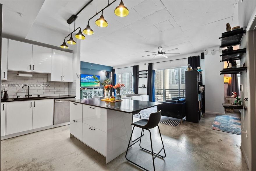 Sophisticated 2BR/2BA loft-style residence in the heart of Downtown Miami with beautiful skyline and bay views from the 16th floor. True open-concept living with 10-ft ceilings, exposed concrete accents, and floor-to-ceiling impact windows that flood the space with natural light. Sleek renovated kitchen featuring new cabinetry, oversized island, and stainless steel appliances. Custom closets, smart features, and in-unit washer/dryer complete this modern urban retreat.

Enjoy resort-style amenities including ground and rooftop pools, hot tub, fitness center, sauna, media lounge, and more. Unmatched walkability—steps to Bayside, Whole Foods, Publix, Brightline, MetroMover, and Downtown’s top restaurants and nightlife. Financially strong building with cash reserves, no special assessments, conventional financing available (as little as 3% down for qualified buyers). HOA includes water, internet, and cable. 30-day minimum rentals permitted, up to 12 times per year.