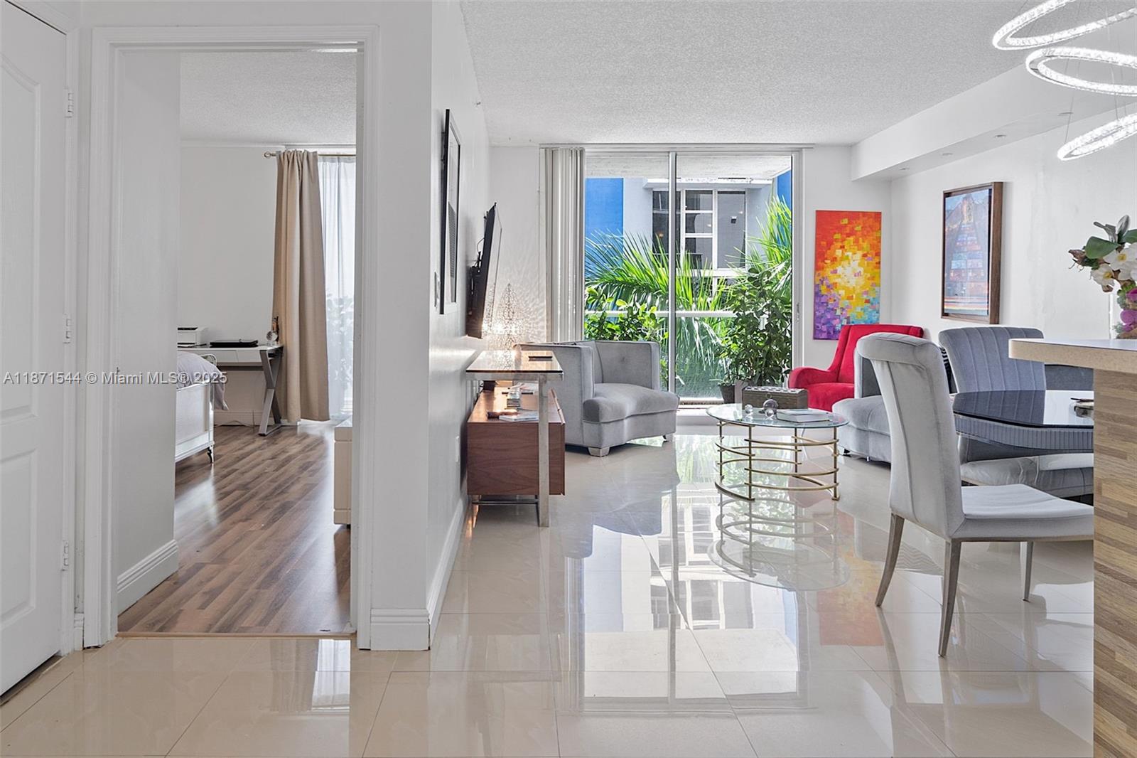 A Must See!!!! Location, Location, Location!!! Great condition. Beautiful and conveniently located condo unit at Blue Lagoon Condominium, just minutes from Miami International Airport! Spacious 862 sqft interior + expansive terrace boasts breathtaking views of Blue Lagoon. Porcelain floors in living area, laminated floors in master bedroom. Impact windows, one assigned covered parking. Updated bathroom. Updated kitchen with granite countertop (2025), appliances (2016), sink & fauscet (2025), water heater (2022), A/C (2020), microwave (2023) & hood (2024). Enjoy this resort-style community with numerous amenities: temperated pool, hot tub, clubhouse, gym, pool table, BBQ area, cabana, mini golf, kids' playground & more!