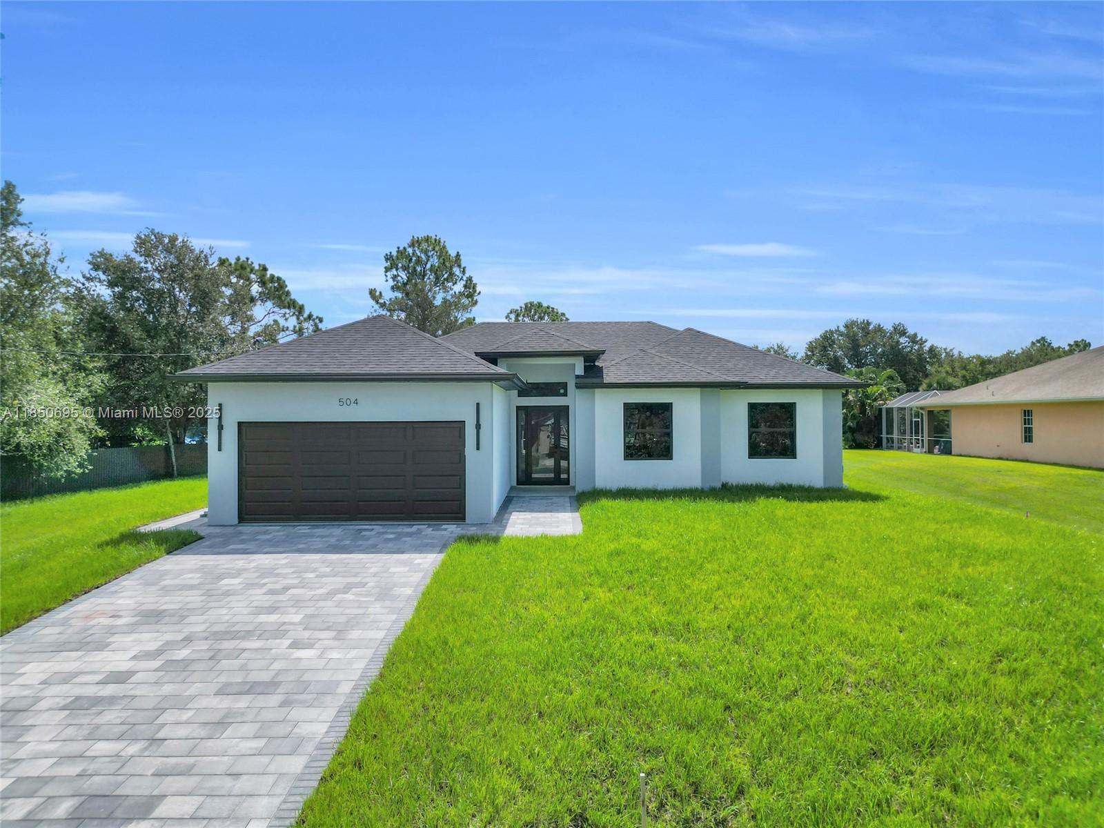Seller is offering $10,000 in concessions toward buyer’s closing costs and prepaid items—an incredible opportunity! This brand-new home in Lehigh Acres sits on a spacious half-acre lot in a quiet, family-friendly neighborhood near William Ave and Lee Blvd. Designed for comfort and style, it features impact windows, 10-foot ceilings, sleek tile flooring, and high-end finishes. The kitchen boasts premium LG appliances, and the laundry room includes a washer, dryer, and utility tub for convenience. Outside, enjoy an epoxy-coated garage floor, paver driveway, and side entrance perfect for parking trucks, boats, or a future RV pad. With space for a pool and a layout built for modern living, this move-in-ready home blends quality and potential in one of Lehigh Acres’ most desirable areas!