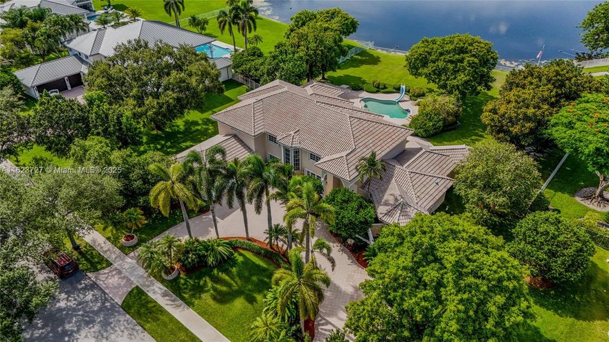 First time ever on the market, this beautiful estate is located in the prestigious gated community of Westridge in Davie. Arguably the best lot location in the neighborhood, it sits on a generous builder's acre at the long end of the lake, which offers a great water view and the utmost privacy. Enjoy this OASIS with a freeform pool and covered cabana area that provides for great entertainment. It includes an oversized circular driveway, a 3 car garage, game room, guest room, huge laundry room, built-in office off primary suite and a water filtration system that provides clean water to the whole house. Close to highways, and vicinity to the port and airport of Fort Lauderdale, this home is a true treasure.