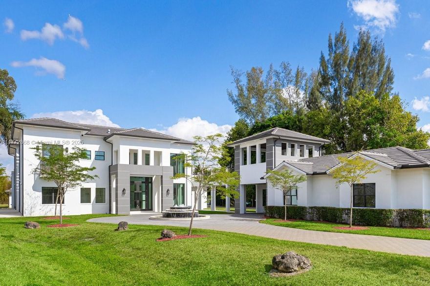 Magnificent Estate in the highly desirable Southwest Ranches. This 12,000+ SF contemporary masterpiece on 1.33 acres offers 7 en-suite bedrooms, 8.5 baths, a private detached guest house, theater room, plus an office, marble staircase, pool & spa, and interior commercial-grade elevator. At its heart, an indoor courtyard with a glass skylight showcases a stunning 20’+ Regal Palm. Beautiful chef’s kitchen boasts solid stone finishes, top-tier appliances, a butler's kitchen, and a walk-in pantry. Designed for entertaining, with a resort-style freeform pool featuring a beach entry and swim-up bar facing the fully equipped summer kitchen. A 4-car garage provides ample space, while gated entry and advanced security ensures privacy. A true blend of modern elegance and resort-style living.