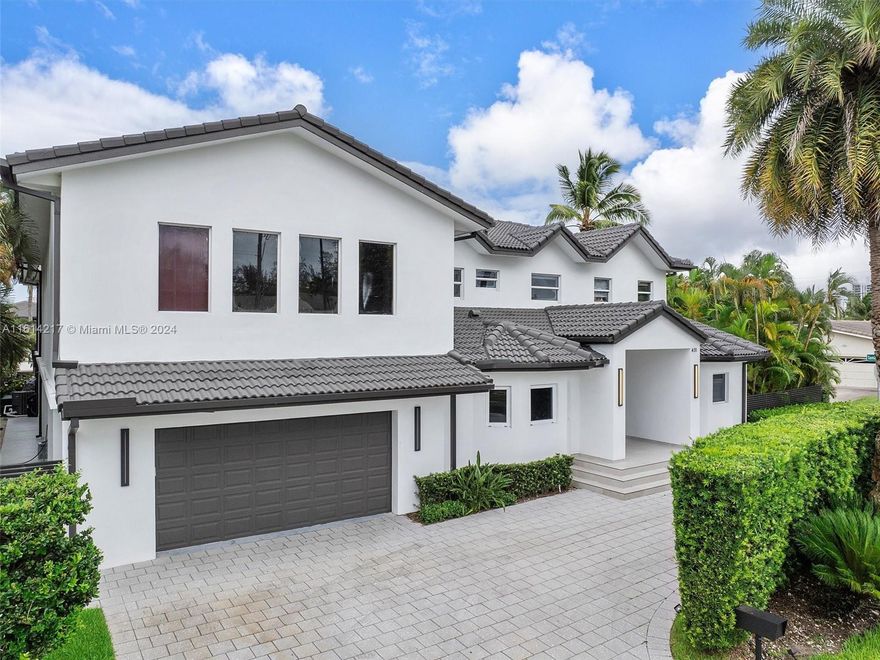 Absolutely stunning waterfront residence in Golden Isles boasting a massive 15,000 SF lot and 100 feet of pristine waterfrontage. This corner lot gem offers unparalleled deep-water access with no fixed bridges. Recently remodeled to perfection with high-end finishes, the home spans over 6,000 SF of luxurious living space featuring 6 bedrooms and 5 full bathrooms plus 2 half baths. Located in a prestigious gated community with top-tier security, this exquisite home is nestled near a park and a new state-of-the-art tennis facility. It's a haven for luxury living, offering unparalleled comfort.Don't miss the chance to experience this lavish lifestyle firsthand—