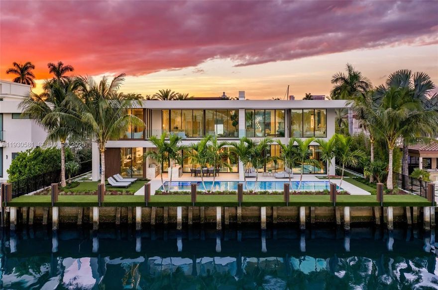 Positioned on a premier stretch of Isle of Palms Drive in the coveted Las Olas Isles, this New Construction waterfront estate offers 100 feet of wide-canal frontage and a commanding architectural presence. Set on an expansive 13,000-square-foot lot, the home captures sweeping water views while maintaining exceptional privacy and scale.

A flawless floor plan supports both elevated daily living and effortless entertaining. Interiors designed by Michael Gray are enhanced by state-of-the-art custom lighting, bespoke millwork, and meticulously book-matched stone, reflecting an uncompromising level of craftsmanship throughout.

The chef’s Mia Cucina kitchen serves as the centerpiece of the home, featuring custom cabinetry, premium appliances, and striking stone finishes ideal for intimate gatherings or large-scale entertaining.
Additional highlights include a stunning wine cellar, private maid’s quarters, and thoughtfully integrated service spaces. The residence comprises seven bedrooms, seven full bathrooms, and a well-appointed powder room. Spa-caliber baths with custom millwork and refined stone selections create serene, resort-like retreats within each suite.

From its expansive waterfront setting to its precisely curated interiors presents a rare opportunity to own a design-forward waterfront home in one of South Florida’s most exclusive enclaves.