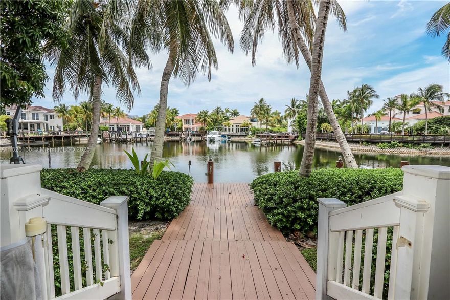 Welcome to your own paradise in this one-of-a-kind waterfront retreat/ Nestled along a wide deep water canal, this 5-bed, 2 bath + 2 half bath home offers over 3,500 sq ft of serene living space. Ideal for boat lovers, this home features a 60’ deep water dock with electric and lighting, plus a wide turnaround for easy navigation. Inside, bright coastal-inspired interior flows effortlessly to two large covered porches—perfect for outdoor dining. The kitchen features 2 refrigerators, 2 dishwashers, granite counters, a wine cooler, double ovens, and 2 sinks—making it ideal kosher kitchen setup. The oversized master suite upstairs is complete with its own private deck overlooking the water, an ensuite bath, and a spacious walk-in closet. Plus 2 addtl rooms for office/gym.