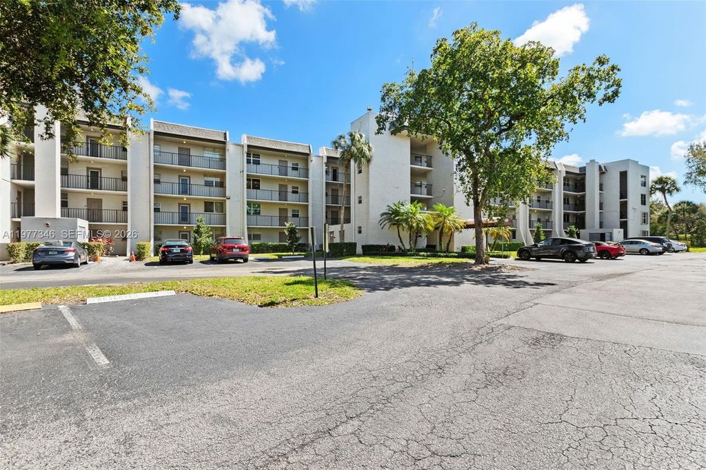 Photo of 9480 Poinciana Pl #407, Davie, FL 33324 (MLS # A11977346)