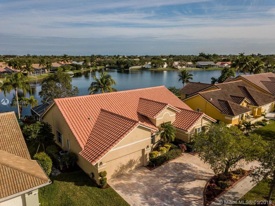 Oh yes..what a beautiful maintained and updated home by original owner!  Home features 4 bedrooms with 2.5 bathrooms, pool and a million dollar view of the lake! Totally remodeled kitchen with custom wood cabinetry, granite countertops, stainless steel Kitchenaide appliances featuring 2 ovens and a microwave! One bedroom is totally build out with shelving and desk. More fabulous features of this home include updated double entry doors*Circular driveway with Eurotile finish*indoor laundry room*screened patio with pool and raised jacuzzi*summer kitchen*pull down attic stairs*Accordion Hurricane shutters*custom french doors leading to patio*Nest thermostat*8 ceiling fans*upgraded ADT security system and monitoring*lush landscaping*leaders and gutters plus more! Don't miss out on this beauty!