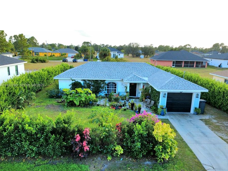 Location, comfort, and privacy come together in this beautifully maintained 3-bedroom, 2-bath single-story home in Lehigh Acres. Featuring tile flooring throughout and a split-bedroom floor plan, the layout is both spacious and highly functional.
The property is surrounded by lush, mature Clusia hedges, offering exceptional privacy and a peaceful, secluded feel. The landscaping is thoughtfully curated with vibrant hibiscus, polycaprio, copper leaf plants, and a stunning bougainvillea vine — the beautiful flowering vine with spikes — adding rich color, texture, and tropical charm. Exterior landscape lighting illuminates the greenery beautifully at night, enhancing curb appeal.
A brand-new roof and upgraded central A/C ensure comfort and low maintenance. The front exterior also features decorative vines supported by discreet wires (not attached directly to the wall), ensuring no damage to the home. Buyers can choose to keep the vines as-is or have them professionally removed.
The outdoor area is perfect for entertaining, complete with a built-in outdoor kitchen and ample room to add a private pool if desired.
This home is conveniently located in a low-flying plane zone, where planes can be seen clearly as they pass above — an exciting feature for aviation enthusiasts.
Situated in a quiet neighborhood with easy access to SR-82, Fort Myers, RSW Airport, shopping, and dining, this move-in ready home offers style, functionality, and value — a rare opportunity in Lehigh Acres.