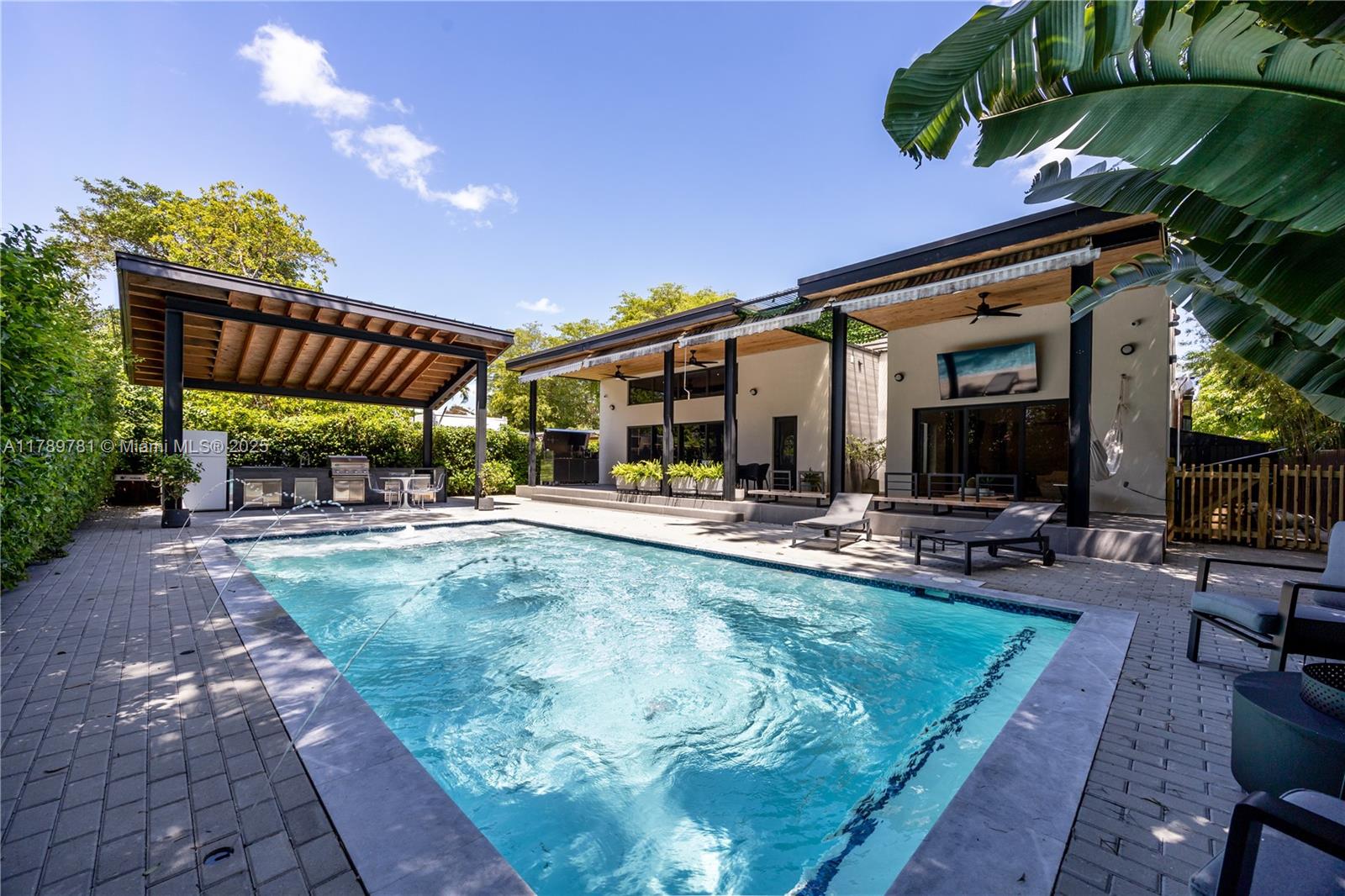 3/3 Sleek & Elegant, this Modern pool residence epitomizes indoor and outdoor living. oversized Lot with a backyard that is your own complete Private Tropical Oasis. Completely renovated in 2023 along with a spacious newly constructed expansion, new plumbing, electrical, roof, 15'x30' pool/Jandy equipment, AC System, and much more. Masterfully Designed for entertaining and family living, the light-filled open floor plan includes a new Italian design Kitchen that opens up to the patio 42 Bottle wine-cooler and Bosch Appliances. The private Master suite features a Build Close design, shower, oversized soaking tub. Also include a Spain wood floor and vanities, Dekton countertops, Italian design doors, and a dramatic 12.5ft celling height. Prepare to fall in love with this one-of-a-find.