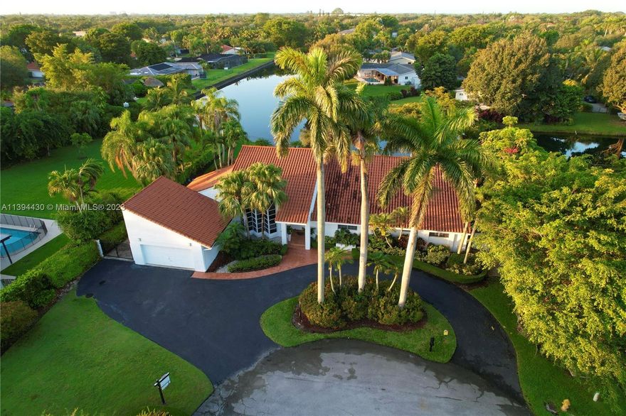 Experience luxury in this rare find nestled in a Pinecrest's quiet cul-de-sac. This waterfront home boasts natural light, wood floors, family room w/vaulted ceiling & bar, plus a den/office. Remodeled kitchen w/ a large cooking island and breakfast nook, modernized bathrooms, a newer roof (2016), new electric panels and wiring (2021), LED lights and modern switches (2022). Popcorn ceiling has been removed, outdoor and pool lighting installed, lateral and back security gates for added security (2022), Pool resurfaced (2012). Built-in desks have been added to the kids' rooms and office (2023). Enjoy spectacular views of the pool and canal from throughout the home. Conveniently located w/excellent public/private schools. Close to shops, supermarkets & wonderful parks.