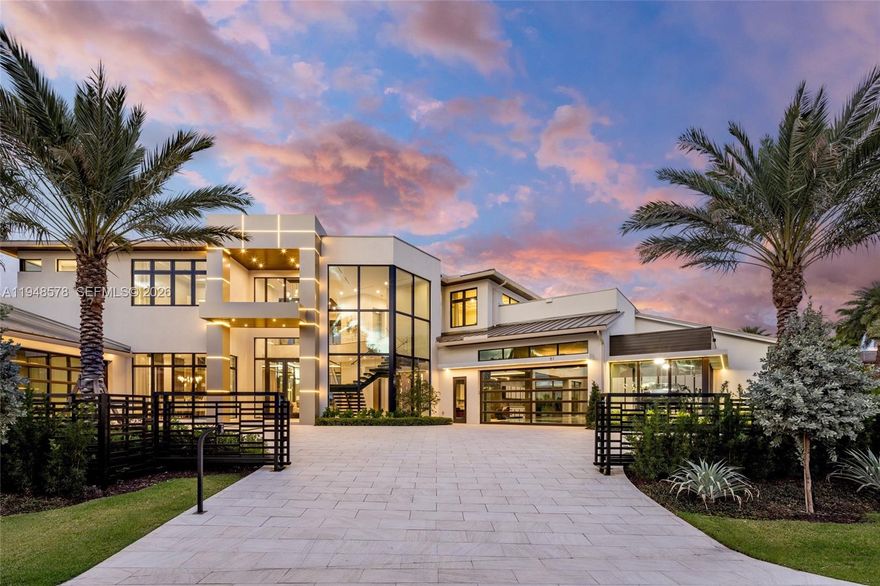 A truly one-of-a-kind waterfront estate, designed without compromise for the serious collector, entertainer, and yachtsman. Located within the prestigious Harbor Beach community, this architectural statement spans nearly 13,000 square feet & delivers 6 bedrooms, 6 full & 2 half bathrooms, offered fully furnished with bespoke, curated interiors. At its core is an extraordinary 3,000+ square foot, air-conditioned showroom garage engineered for vehicle lifts to accommodate 15+ cars, complemented by a separate 20’ x 20’ two car garage. Interiors impress with 48” porcelain flooring throughout, a dramatic floating staircase, custom ceiling details, 12-ft second-floor ceilings, and walls of glass framing serene water views. The chef’s kitchen features Italian Cesar cabinetry, Taj Mahal stone countertops, Wolf and Sub Zero appliances, a butler’s kitchen with integrated coffee system, and three dishwashers. Additional highlights include dual laundry rooms, elevator, gas systems, & fully built out closets. The first floor club room offers a private lounge experience with a pub-style full bar, wine coolers, & kegerator, complemented by dedicated media, gym, & theater rooms. Outdoor living rivals a private resort with a heated saltwater infinity pool, summer kitchen, primary suite terrace with outdoor bar, stained oak ceilings, & a new concrete dock & seawall with pedestals & generator providing immediate ocean access just minutes from the beach and Fort Lauderdale International Airport.