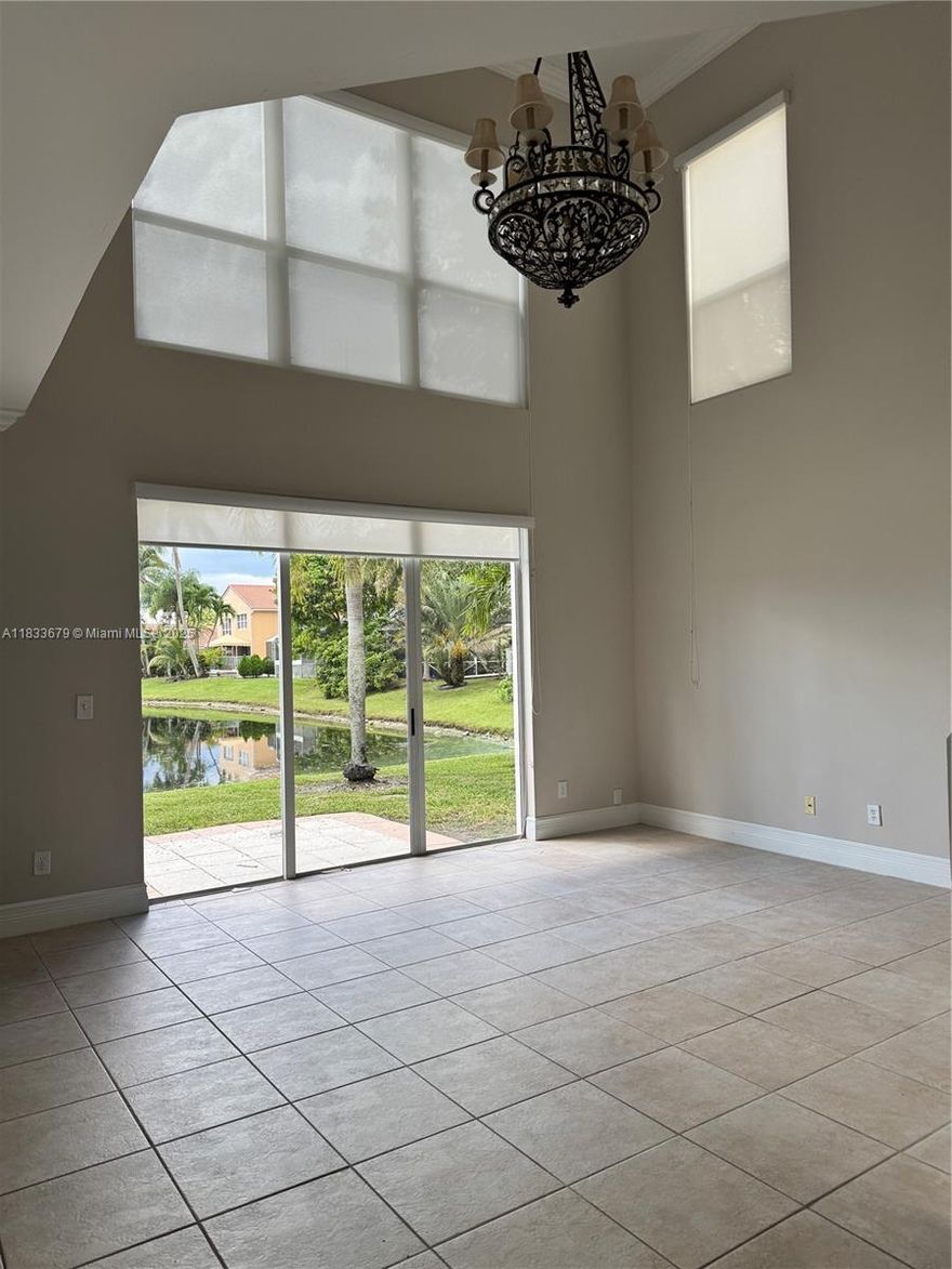 Beautiful, 4/2.5 lakefront house 2 car garage in desirable A+ school district. Gorgeous long lake front view in secure, quiet, gated Kensington community. Granite, Stainless Steel appliances, Real Wood cabinets, Roller shades and plantation shutters throughout first floor. Neutral tile floors, Large walk in master closet w/ensuite roman tub and separate shower. New Vanities with Quartz countertops in guest bathroom, Marble top Vanity in Master. First Floor 1/2 bath. Association maintained lawn care, irrigation from lake. Energy efficient appliances equals low Power bills. Large community pool, Publix and Costco next door. Community Park /playground within walking distance. Bike and walking trails surround community. Close to highways, shopping and restaurants.
