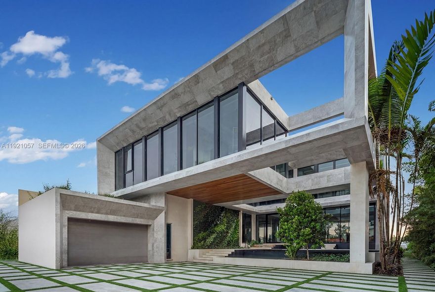 Step into this stunning waterfront masterpiece where luxury meets sophistication on guard gated Hibiscus Island. This new architectural marvel designed by Kobi Karp offers 8,300 SF of meticulously crafted living space curated by Argent Design blending art & architecture. Inspired by iconic sculptures, this estate pushes the boundaries of design, creating a home that's not just a place to live, but a living work of art. The entrance sets the tone w/ an architectural stone facade, living green wall, Koi pond & outdoor firepit. With soaring 11'6" ceilings & exquisite finishes throughout, this will impress the most discerning buyer. 7 bedrooms & 8 total bathrooms provide generous accommodations, while wide plank white oak floors, custom millwork & imported stone create an atmosphere of refined elegance. The SW exposure frames downtown Miami's skyline & delivers breathtaking sunset views. Your 90FT of water frontage becomes your personal paradise, enhanced by lush tropical landscaping by CLAD Landscape Architecture. Amenities include and commercial elevator which services all 3 levels, Savant system, Bon Vivant kitchen & chefs prep kitchen, outdoor kitchen, resort style pool, generator, custom stone bar w/ built in aquarium, 2 car AC garage & air conditioned rooftop entertainment level w/ the best views Miami has to offer. This 24HR guard-gated community offers tennis, basketball, & playground, just minutes from the best shopping & dining in South Beach & Design District.