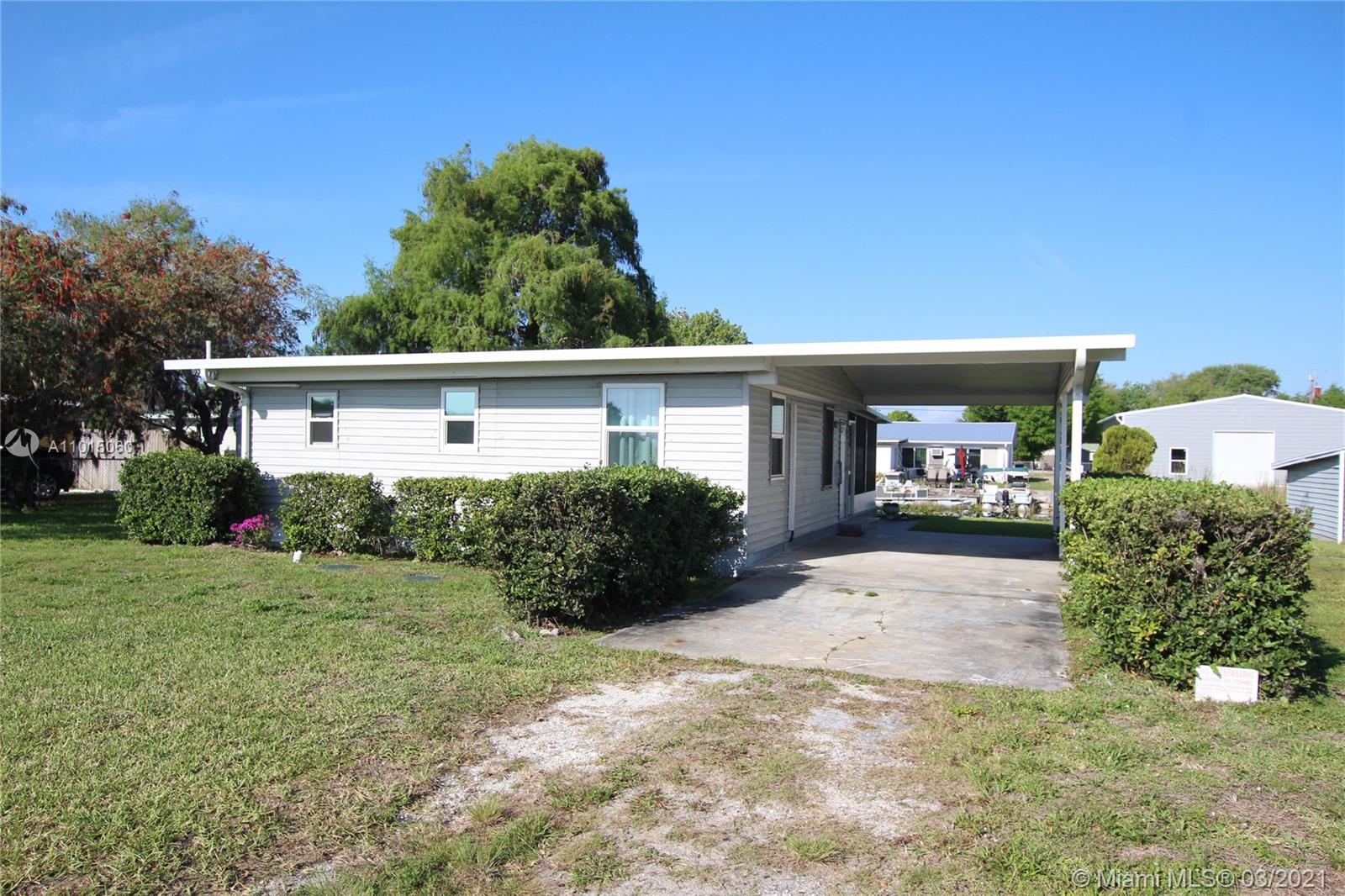 LAKE OKEECHOBEE ACCESS - This is a one-of-a-kind, completely renovated 2/1 on a double lot with boathouse and boat ramp. Newer Aluminum seawall on both lots. The home is beautifully renovated with nice sized bedrooms, brand new kitchen, large comfortable bathroom and indoor laundry. Completely rewired with 200 amp underground utility service, all new plumbing to include an on demand endless water supply hot water heater, and all new PGT double pane hurricane windows and doors. Brand new split A/C and heat installed with individual controls for each bedroom and living room. The renovation was finished off with an immense screen room build from marine grade lumber that will last a lifetime. A one of a kind opportunity, move-in ready. Septic was pumped and inspected. Low electric bills.