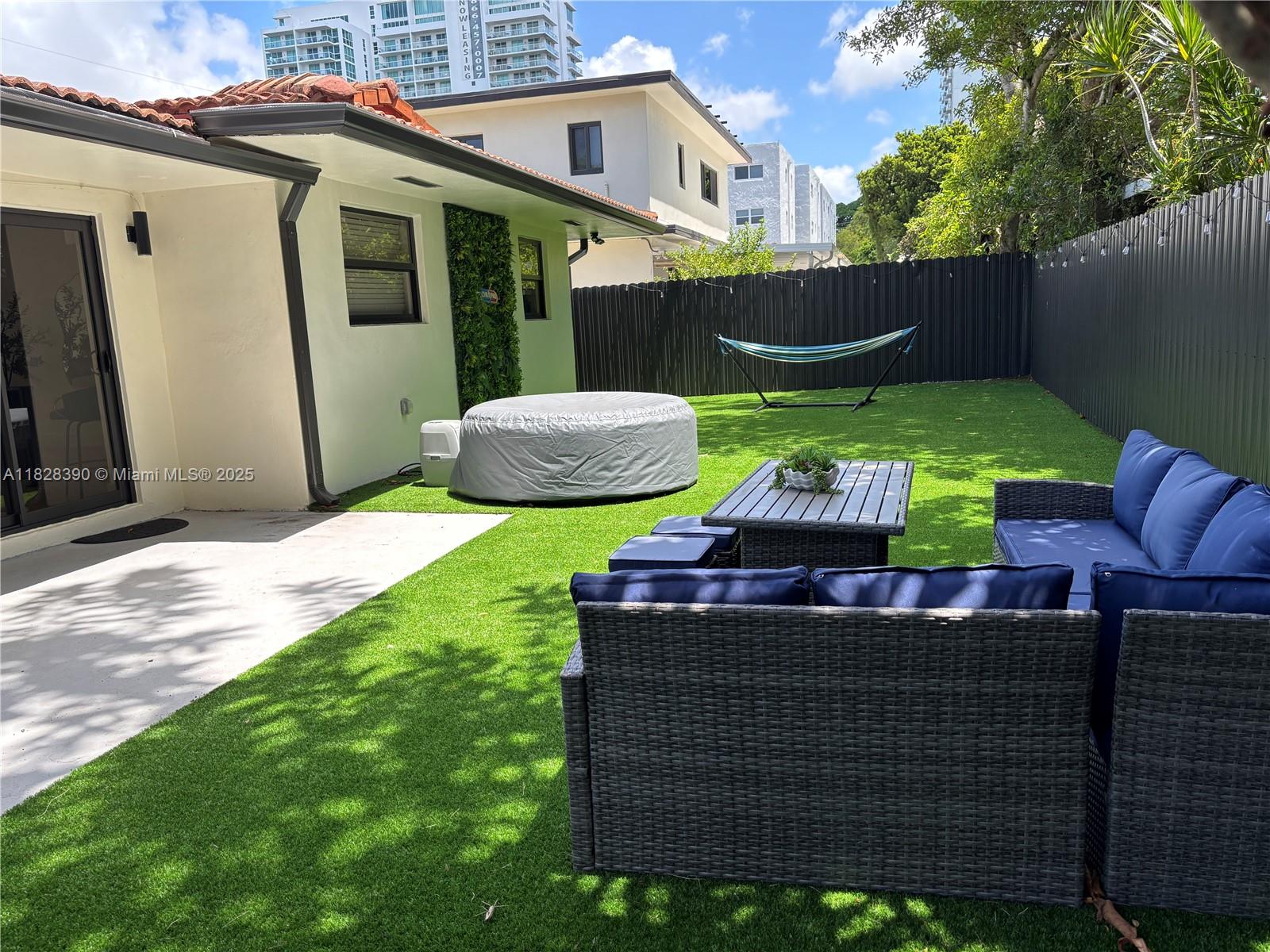 Stylish, fully renovated home featuring a new kitchen, bathrooms, plumbing, electrical system, flooring, and impact windows. Enjoy brand-new appliances, upgraded insulation, a private fence and a secure gate. Outdoor living is a dream with a jacuzzi, BBQ and dining area nestled under the trees. This furnished 3-bedroom, 2-bathroom home also includes a versatile 1/1 studio-ideal for work, guests, or creative space. Located in a walkable, green neighborhood near the Miami River, Downtown, Calle 8, Wynwood, and the Design District. Move-in ready and perfect for families.
