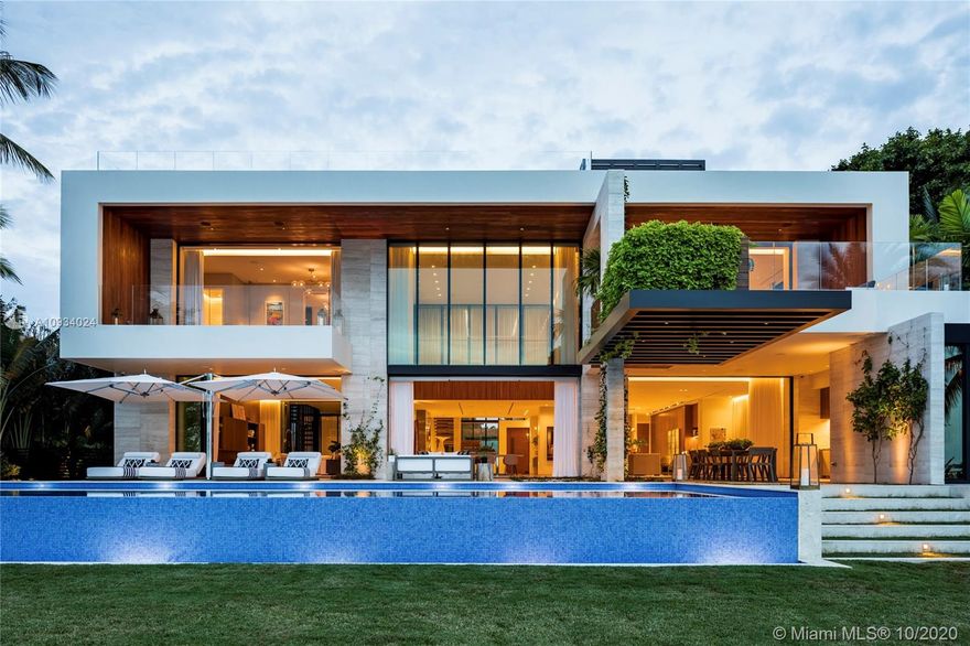 Warm & inviting, this Tropical Modern residence presents an ipe wood and Italian stone facade of architectural splendor. 224 BAL BAY was conceived by top design minds Ralph Choeff and Deborah Wecselman. Expansive retractable glass doors epitomize indoor-outdoor living with Western views. The attention to detail from stunning millwork to a custom mosaic wall to a fitness studio overlooking the bay exemplify that this is a primary owner's home. The master boasts 2 large terraces, dual closets, & private office. Spend your days at the 50ft infinity pool and your evenings lounging on the 1,500sq.ft rooftop terrace. With too many features to name, this home represents the budget-less including $1mil+ in automation. Private access to Bal Harbour Shops & the beach from elite Bal Harbour Village