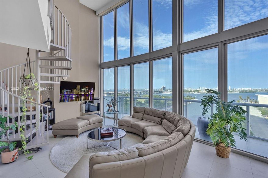 One-of-a-kind southeast corner 2-story loft at Marina Blue, located in the heart of Miami Worldcenter. This fully furnished gem features 18ft floor-to-ceiling glass walls with stunning panoramic views of Biscayne Bay, the Kaseya Center, Museum Park, and the Downtown Miami skyline from every room. Impeccably designed with porcelain floors, stainless steel appliances, motorized shades, blackout curtains in the bedroom, and a showstopping chandelier in the living area. Amenities include two pools, gym, BBQ, volleyball court, and more. One assigned parking space.
