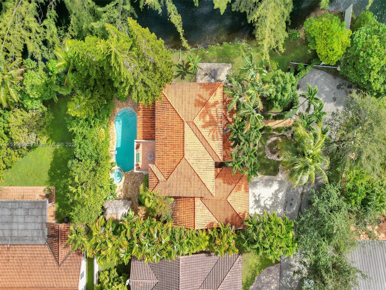 Welcome to this tropical haven surrounded by lush landscaping, making this home the perfect backdrop for serene living. Inside, discover this completed updated home. The open staircase is not just a path to the upper level but a style statement. The chef's kitchen is equipped with S/S appliances, custom wood cabinets, & exotic granite countertops. Cook & watch nature unfold from your picturesque windows. This 4/4 + office/ den that includes a first floor suite great for in-laws or guest. The primary suite with its large private balcony & spa like bath tub / shower enclosure makes this the perfect place to unwind. Private and lush backyard that includes a heated pool, gazebo with summer kitchen & amazing creek side views. Enjoy nature & all the wildlife that Florida living has to offer.