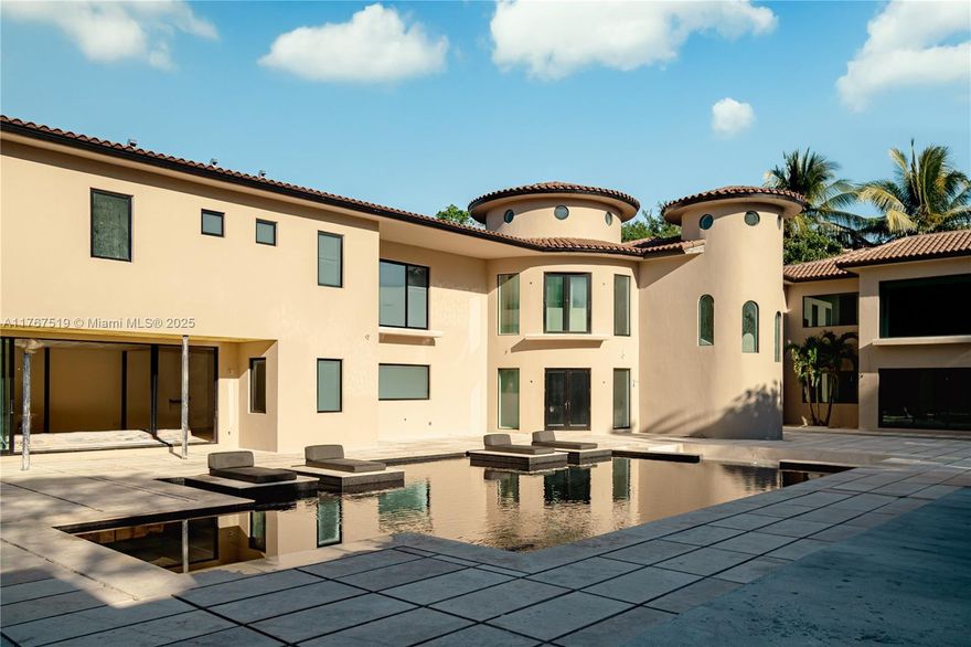 Nestled on a sprawling 40,946 SF lot in North Pinecrest, this resort-inspired estate is designed for ultimate luxury and relaxation. Influenced by the serene elegance of Nizuc Resort, Amangiri’s minimalist sophistication, and Japanese wabi-sabi aesthetics, this modern hacienda, Casa Piedra, seamlessly blends nature and architecture. Set for completion in Spring 2025, the 9,000 SF main residence and 2,000 SF pavilion are united by a stunning Balinese-style pool, the nucleus of the home. With 11,400 SF under air, the estate offers 10 bedrooms, 9 full baths, and 2 powder rooms. A lavish primary suite, chef’s kitchen, grand rotunda, media room, and resort-style amenities create a private oasis perfect for intimate retreats or grand entertaining.