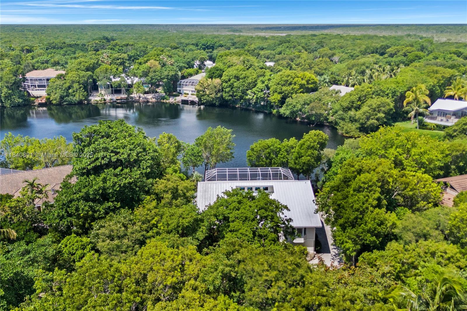 This renovated lakefront home offers comfort, style, and serene views. Thoughtfully upgraded, the 4-bedroom, 4-bath residence features a new roof, impact-rated windows and doors, a custom kitchen, spa-like bathrooms, and tastefully designed bedrooms. A loft room provides flexible space for a kids' playroom or media lounge. The open-concept layout fills the home with natural light and showcases stunning lake views, creating a seamless transition between indoor and outdoor living—ideal for entertaining or quiet relaxation. Move-in ready and meticulously updated, this home combines privacy, luxury, and convenience—all within the exclusive Ocean Reef Club. Enjoy world-class amenities, including championship golf, a full-service marina, a private airport, and a variety of dining options.