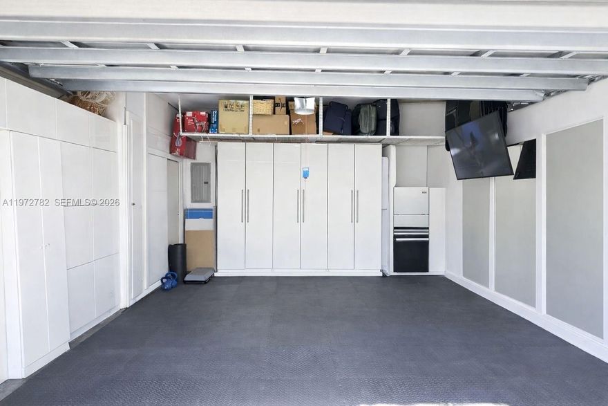 Discover a rare offering on prestigious Island Way—a fully renovated two-story residence where elegance and serenity exist in perfect harmony. Set on a private corner lot beside the community pool, this modern sanctuary blends beauty, location, and lifestyle effortlessly. Wrapped in cascading ivy, the home presents a romantic façade crowned by a new barrel roof, impact windows and doors, and a two-car garage with driveway parking for two additional vehicles.
Beyond the entrance, a private courtyard and heated pool with jets and ambient lighting create an intimate retreat, complemented by a versatile indoor-outdoor cabana room ideal for entertaining, a home office, gym, or lounge. Inside, soaring ceilings, porcelain floors, and airy volumes enhance the seamless indoor-outdoor flow. The open chef’s kitchen features a spacious island, induction cooktop with hood, wine cooler, and paneled Sub-Zero refrigerator, while fully renovated bathrooms add refined comfort. A sleek wooden staircase with glass railings connects both levels, reflecting modern sophistication.
Additional upgrades include a new AC system with Nest thermostat and new water heater for efficiency and peace of mind. Just steps away, enjoy tranquil strolls along the scenic Waterways Walkway, with waterfront views and gentle breezes shaping your daily rhythm. Ideally located, top-rated schools, hospitals, fine dining, and shopping, offering privacy, luxury, and convenience at your doorstep.