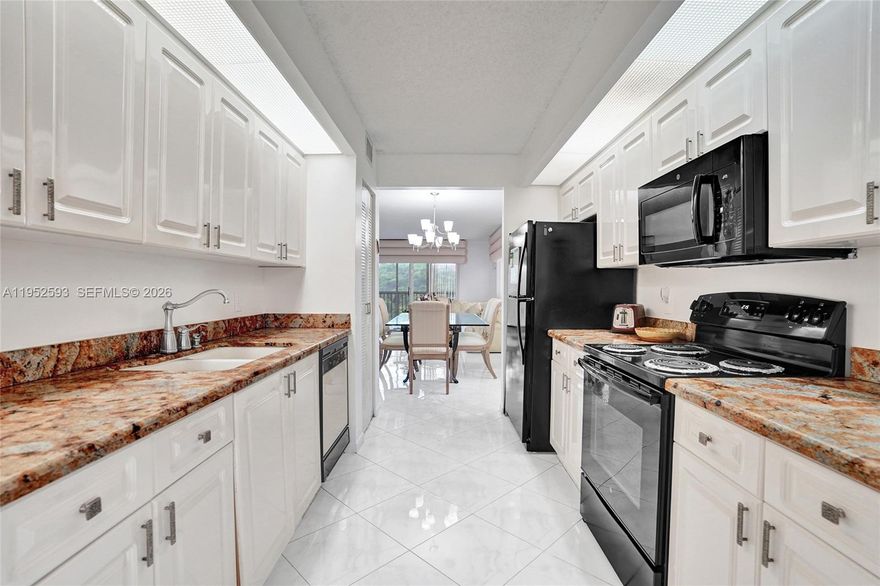 Beautifully updated 3rd-floor corner Magnolia in one of Century Village’s newer buildings. The community’s largest, most sought-after layout, with no building next door—flooded with natural light. Brand-new A/C, lightly used electric range, and tasteful finishes make this home move-in ready. Spacious galley kitchen with large breakfast nook, granite counters, and wood cabinetry. Primary suite with double-sink vanity; both bedrooms feature walk-in closets. Upholstered cornices and the corner kitchen display case are included; additional furnishings are available for a fee. Large light-toned, marble-look tile set on the diagonal unifies the entry, kitchen, and living areas. Enclosed porch with pool and garden views. Assigned parking directly in front, plus ample guest parking. Enjoy resort-style 55+ amenities: clubhouse, courtesy transportation, fitness centers, pools, tennis, movie theater, billiards, on-site pharmacy, café, golf, and more.