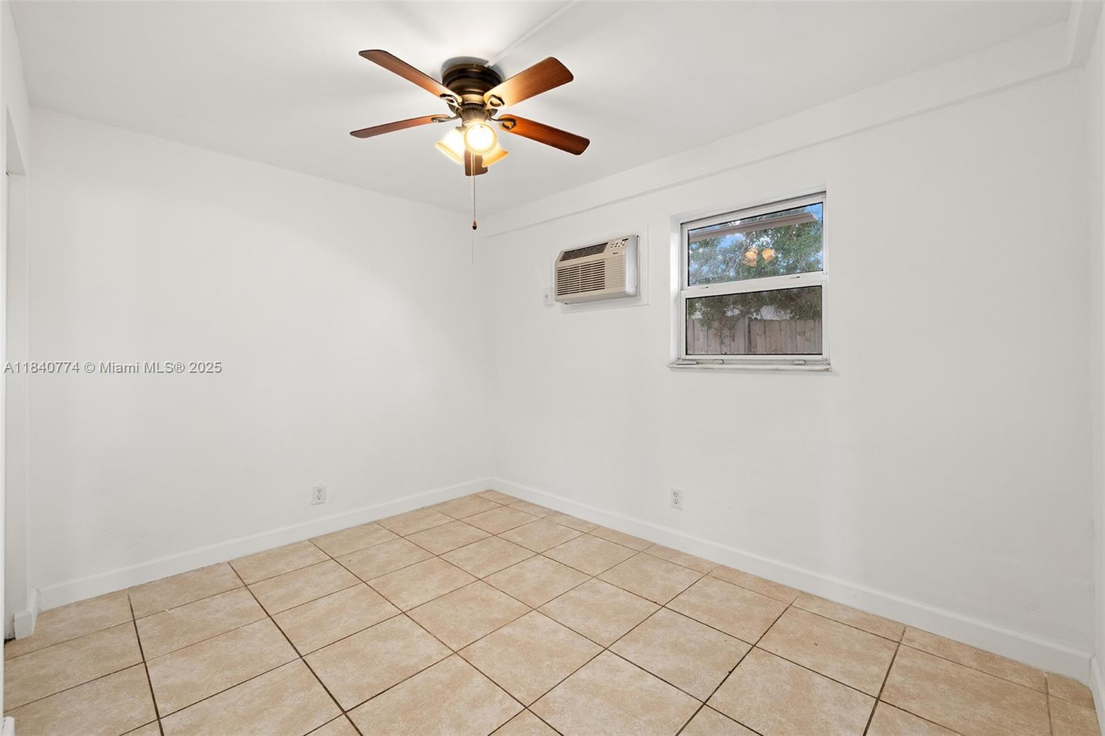 Prime Victoria Park Rental Opportunity! Charming 2-bedroom, 1-bathroom unit available in a quiet, well-maintained neighborhood. This freshly painted residence features tile flooring throughout, window A/C units for personalized comfort, and ceiling fans in both bedrooms and the living area. The updated kitchen offers modern cabinetry along with essential appliances, including a refrigerator and stove. The bathroom is bright and functional with a tiled shower. Multiple windows provide abundant natural light. Situated in a building with a distinctive yellow exterior, landscaped lawn, and a fenced outdoor area—ideal for relaxing and enjoying the surroundings.
