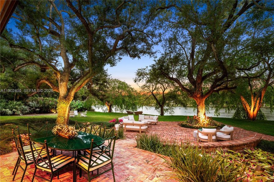 Welcome to an enchanting lakefront residence nestled within the prestigious gated enclave of Banyan Drive in Coral Gables. Remodeled in 2024, this spectacular contemporary estate offers 6,239 square feet under air, w/7,611 total square feet, set on over an acre of lush grounds graced w/majestic oak trees & sweeping water views. Hand-picked by the owner for its expansive lake vistas & the pleasure of continuous prevailing breezes, this elevated architectural masterpiece harmonizes seamlessly w/its natural surroundings & features an exceptionally low carbon footprint. Warm wood floors, brand-new chef’s kitchen, new spa-inspired baths, & multiple entertaining spaces create a refined yet relaxed atmosphere. Each room is thoughtfully designed to capture abundant natural light & frame breathtaking views of the tranquil lake & verdant landscape. The home’s exceptional orientation & generous outdoor areas make it ideal for both intimate gatherings & grand-scale entertaining w/indoor & outdoor surround sound. Experience nature’s beauty w/early morning sails & sunset kayak rides from your own backyard, embracing a lifestyle that blends elegance, comfort, & recreation. Ideally located near Miami’s finest private schools, this Coral Gables address is uniquely served by Pinecrest Elementary, offering an exceptional educational advantage. This remarkable residence embodies a lifetime of elegance, serenity, & distinction in one of the most coveted lakefront settings. A Very Special Home.