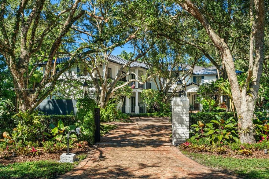 Nestled on a serene tree-lined street in Pinecrest, this 10,694 SF, 8-BD, 6-BA gated Florida coastal home is situated on a sizable 40,336 SF lot. A charming, covered entry opens to a spacious layout with vaulted ceilings. The formal dining room offers a custom temperature-controlled 2,000 bottle wine cellar. An eat-in kitchen features high-end appliances and a large kitchen island which blends seamlessly into the family room. The primary suite boasts walk-in closets and a private balcony overlooking the beautiful backyard. Outdoor areas offer endless options for recreation and relaxation, with a pool, gazebo, summer kitchen, basketball court, and putting green. Additional features include a new metal roof, impact windows/doors, guest quarters, generator, and a 2-car garage.