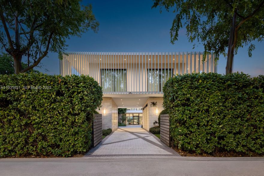 Private island living at its finest. This tropical modern estate, designed by Domo Architecture, sits on a 17,280 SF waterfront lot with 80 feet of water frontage. Offering 7,910 SF of interior living space, the home features 7 bedrooms, 7 full bathrooms, and 2 half bathrooms.

Highlights include a gourmet chef’s kitchen, media room, elevator, and a primary suite with private sitting room. Outdoor living is elevated with a heated pool and spa, outdoor shower, and tranquil koi pond. The property includes a separate guest house and main residence, along with a two-car garage, creating a true private island retreat.