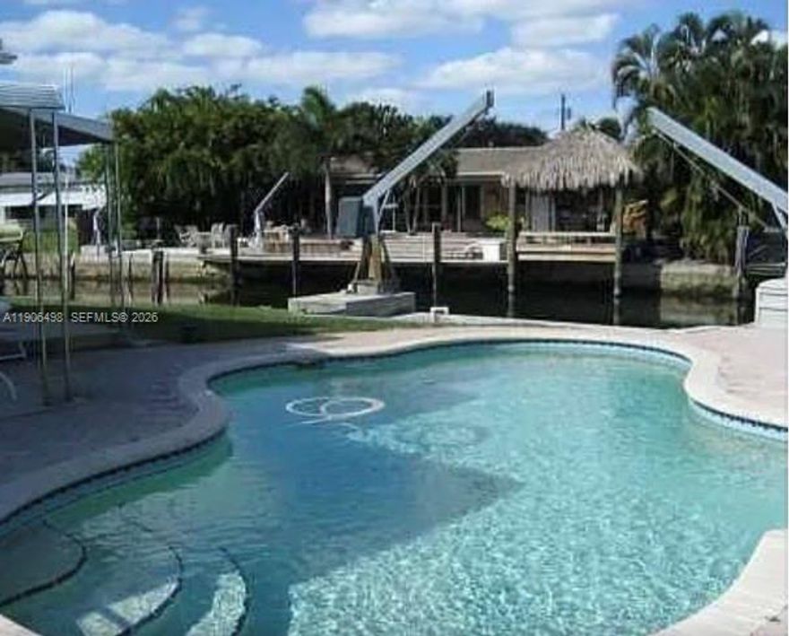 Attention Boaters!!! 100 Ft. Seawall with Ocean Access! 3 bedroom 2 bath spacious home includes a huge back room, off the dining area, with full view of the canal. A Butlers pantry off the kitchen and a laundry room with space for storage and an additional exterior door. Private Master Bedroom with Bath and Walk-In Closet on one side of living room, additional 2-Spacious Bedrooms with Bath between on the other side. Complete high impact/sound proof windows and doors and covered carport. Good size yard with in-ground pool uniquely shaped to fit perfectly on the side yard! Melaleuca Gardens is a Hidden Gem in Dania Beach. NO HOA! Quiet community where neighbors know each other, minutes from everything including Shopping & Restaurants, Dania Pointe, Airport, Interstate, Beach, and minutes to the Ocean from your boat docked right behind your home. Made with good solid Miami-Dade Pine. Clean and move in ready! Very flexible with showing times!