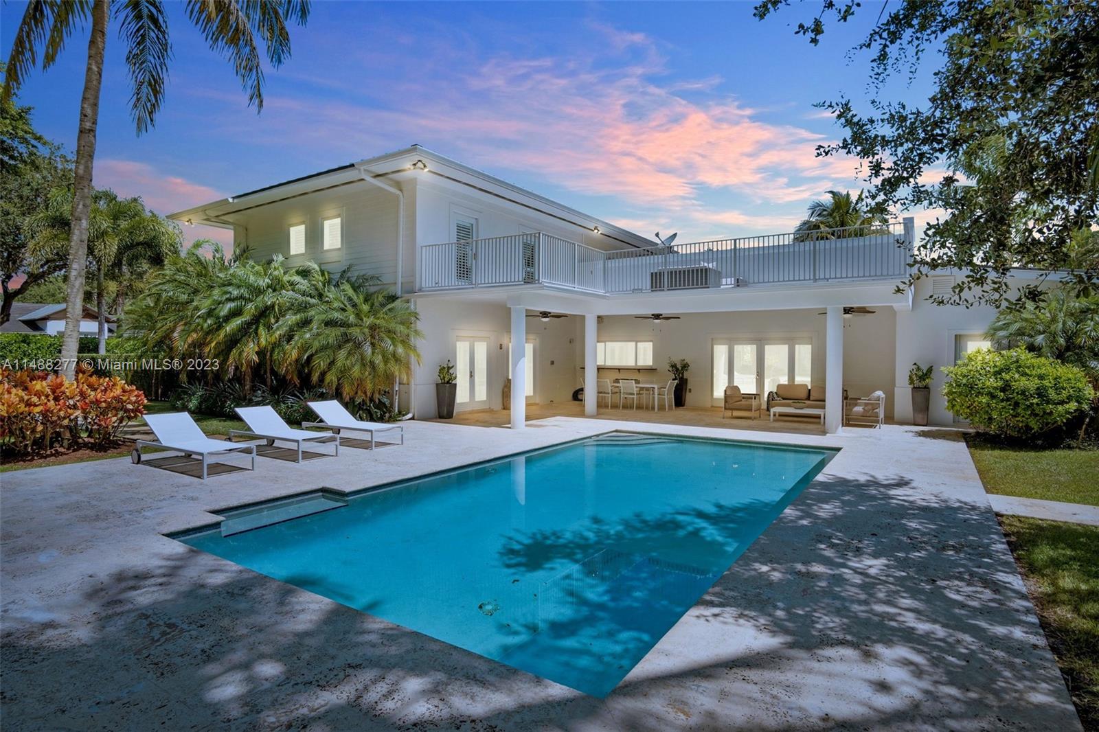 INTRODUCING "CASA BANYAN" situated on a beautiful ½ acre corner lot home, surrounded by lush tropical landscape on a quiet street. The exceptional location and the incredible size of this property presents endless and exciting possibilities for developers and families. Light-filled open living spaces with views of the garden and oversized pool from every angle make this home a true oasis with a large, covered patio, perfect for outdoor entertaining. An ultra-private, lush tropical garden with fruit bearing trees surrounds the tranquil pool and kids dream playground. Chefs kitchen offers high-end appliances, cooking island, built-in wine coolers and a restaurant-caliber ice maker. $50k renders and floor plans included in price.