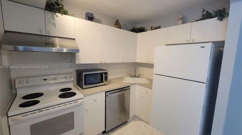 Photo of 1 Jacaranda Country Club Dr #104, Plantation, FL 33324 (MLS # A11874583)