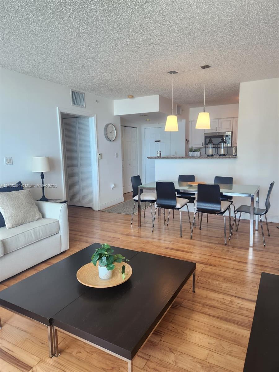 Enjoy sweeping views of the city and bay from this well-designed unit. It features an upgraded kitchen and bathroom with granite countertops, washer and dryer, and access to a full suite of amenities, including a fitness center, racquetball, and tennis courts—all in a desirable luxury building.