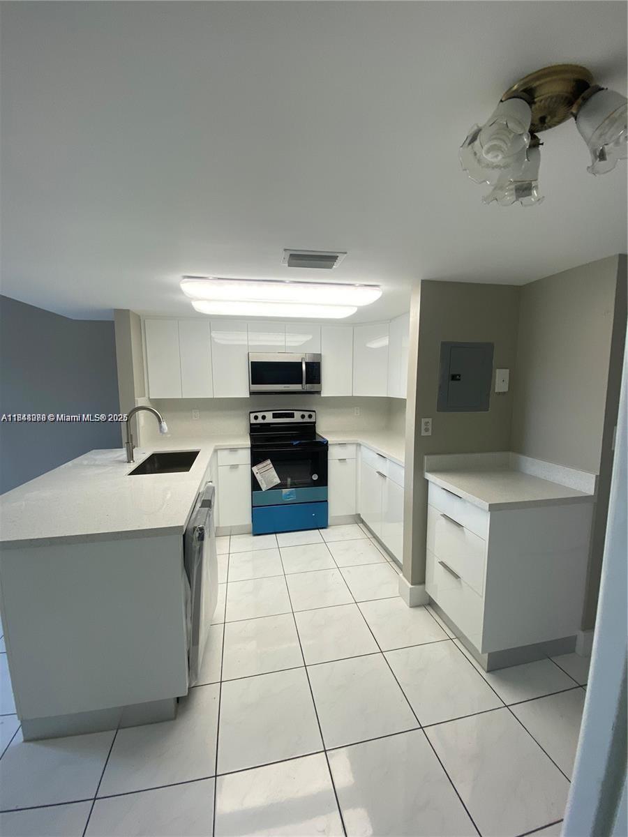 Rare opportunity, Seller will OWNER FINANCE with 20% DOWN! Rented for $2,750! Newly renovated corner 3 bed/2 bath condo in Fern Isle Gardens. This two-story unit is in a prime location & includes a designated parking space right in front, with ample guest parking available. Kitchen features quartz countertops and S/S appliances. Low association dues, ($350 per month) this condo is an excellent option for both residents and investors. Previously leased for $3,100 per month, offering strong rental income potential. The open-concept first floor provides a spacious layout with beautiful city skyline views. Generously sized bedrooms with ample closet space. In unit washer and dryer, elegant oak stairs, accordion shutters, & access to a community picnic area. Seller financing.