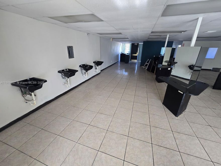 This 2000 +/- SQFT unit is located on the 2nd floor of Marquis Square, a 2-story shopping plaza, with frontage to State Road 7. Unit 215 has lots of natural light and is ideal for a beaty salon! Was a beauty school for 20+ years and was remodeled in 2022. Layout: reception area, open classroom set up with 6 stations, 4 hair washing stations, and a wall w/ 12 electrical outlets. Additionally, there is 1 private office, 2 open offices/storage areas, and 1 restroom. Unit can be converted for other approved business use. Can be combined with Unit 216 for a total of 4,250 +/- SQFT space. Tenant responsible for proportionate share of electric. Located in TOC-C zoning, this plaza has a diverse set of businesses as long-term tenants.