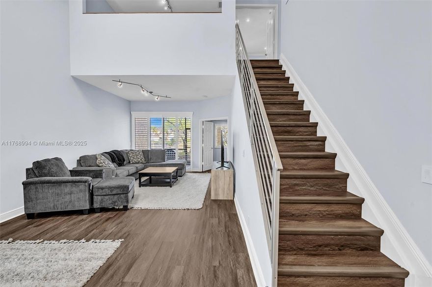 Turn Key Totally RENOVATED 1900+ sq ft 3 bed +den (4th br)/2.5 baths w/wide 2 car attached garage. Immaculate and fully upgraded townhome that feels like a massive SINGLE FAMILY when you enter it! All new renovations were recently done which incl: dark hardwood flooring throughout, 3 coats of brand new custom light gray paint; 3 coats of new paint and new tile floor in extra wide attached garage; custom white cabinets downstairs in kitchen and both bathrooms, quartz countertops in downstairs bath, custom white shutter blinds throughout; The Master bedroom IS DOWN (huge plus!) 2025 NEW ROOF being put on now, exterior new white paint; entire community is being redone to look new! NO SPECIAL, 44K has been paid in FULL by seller! mo/ hoa incl: exterior insurance, roof, alarm, water, cable,pool
