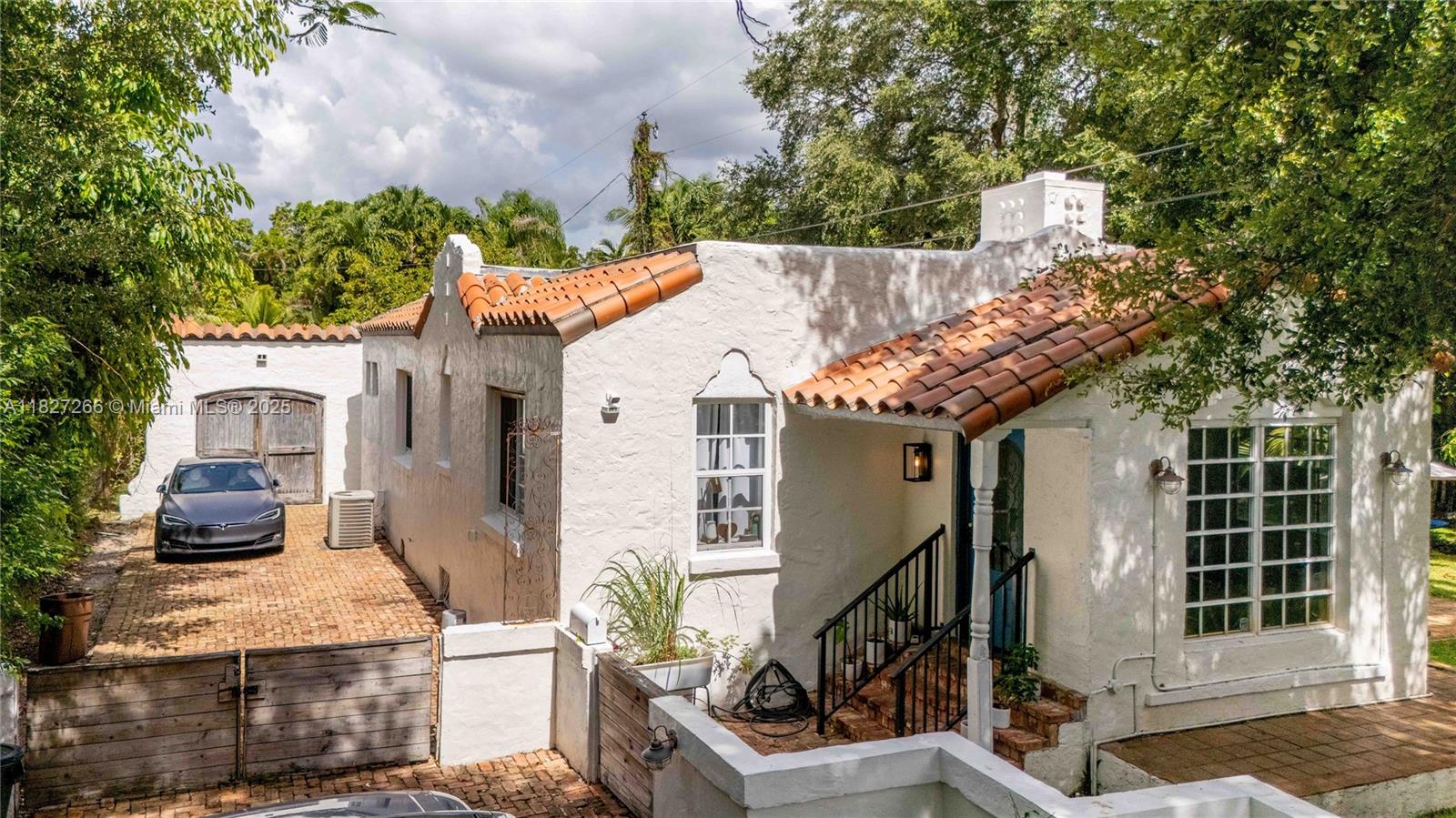 Now available for sale in one of Coral Gables’ most beautiful and quiet streets. This classic Old Spanish 2-bedroom, 2-bath home sits on a gated 9,450 SF lot with mature landscaping and privacy. Filled with original charm, it features wood floors, a decorative fireplace, arched doorways, and abundant natural light. An additional room off the kitchen offers flexibility as a den, office, or creative space. Enjoy peaceful garden views, a one-car garage, and extra parking in the driveway. Ideally located near golf courses, shops, dining, and cultural landmarks.